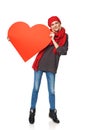 Full length girl holding up a red cardboard heart Royalty Free Stock Photo