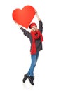 Full length girl holding up a red cardboard heart Royalty Free Stock Photo