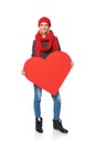 Full length girl holding up a red cardboard heart Royalty Free Stock Photo