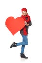 Full length girl holding up a red cardboard heart Royalty Free Stock Photo