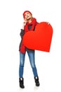 Full length girl holding up a red cardboard heart Royalty Free Stock Photo