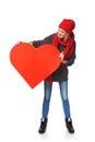 Full length girl holding up a red cardboard heart Royalty Free Stock Photo