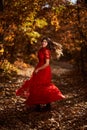 Woman in red dress dancing in the oak forest, full body Royalty Free Stock Photo