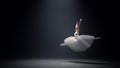 Gorgeous woman soaring in ballet dress on stage. Ballerina dancing indoors.