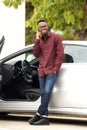 Full length handsome black man talking on mobile phone by car Royalty Free Stock Photo