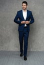 Full length of handsome man wear blue suit isolated on grey background. Royalty Free Stock Photo