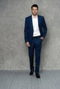 Full length of handsome man wear blue suit isolated on grey background. Royalty Free Stock Photo