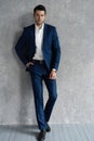 Full length of handsome man wear blue suit isolated on grey background. Royalty Free Stock Photo