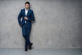 Full length of handsome man wear blue suit isolated on grey background. Royalty Free Stock Photo