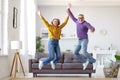 Full length of happy active energetic senior caucasian family couple jumping and having fun together