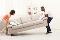 African-american couple placing sofa at new home Royalty Free Stock Photo