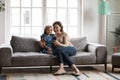 Full length happy mature grandmother and little granddaughter using smartphone Royalty Free Stock Photo