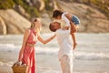 Full length of a happy mixed race family enjoying family time together at the beach. Loving father lifting his daughter Royalty Free Stock Photo