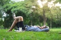 Full length happy smiling man lying and relaxing in park Royalty Free Stock Photo