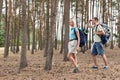 Full length of happy young couple trekking in forest Royalty Free Stock Photo