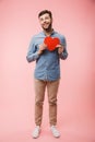 Full length of a happy young man holding red heart Royalty Free Stock Photo