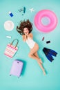 Full length high angle above view vertical flat lay photo of funky lady lying floor surrounded many trip stuff things