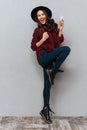 Full length image of cheerful brunette woman in sweater Royalty Free Stock Photo