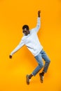 Full length image of happy african american guy smiling and dancing