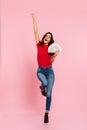 Full-length image of happy brunette woman rejoice and holding money