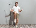 Full length image of a Happy Screaming golfer in sunglasses