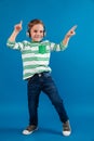 Full length image of happy young boy listening music Royalty Free Stock Photo