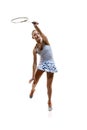 Full-length image of motivated athlete in motion, young girl, badminton player hitting shuttlecock in jump isolated over Royalty Free Stock Photo