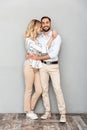 Full length image of nice couple in casual clothing smiling and hugging each other Royalty Free Stock Photo