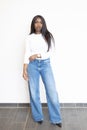 Modern Chic: Woman in White Top and Blue Jeans Royalty Free Stock Photo