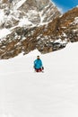 Full length image of a snowboarding standing in a snow, high mountain background Royalty Free Stock Photo