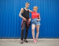 Young modern stylish hipsters couple on blue background, sunny portrait couple teenagers. Royalty Free Stock Photo