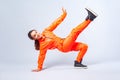 Full length image of vivid happy teenage girl dancing hip-hop, showing move with handstand. white background Royalty Free Stock Photo