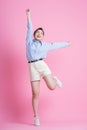Full length image of young Asian woman posing on pink background Royalty Free Stock Photo