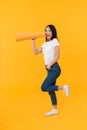 Full length image of young brunette asian woman calling with mouthpiece Royalty Free Stock Photo