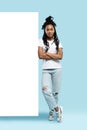 Full length of young woman wearing casual clothes smiling and pointing finger at copyspace isolated over blue background Royalty Free Stock Photo