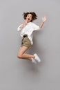 Full length image of young girl 20s smiling and jumping, isolate Royalty Free Stock Photo
