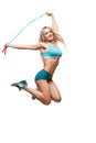 Full length image of a young sports woman jumping on skipping rope over white background Royalty Free Stock Photo