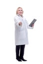 Profile of a pretty doctor with white lab coat, stethoscope smiling and writing notes in clipboard Royalty Free Stock Photo