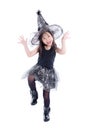 Full length of little asian girl wearing witch costume for Halloween standing isolated over white background Royalty Free Stock Photo