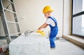 Child using construction tool in apartment under renovation. Royalty Free Stock Photo