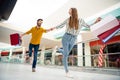 Full length low angle view photo of cheerful pretty lady lead handsome guy hurry next store wanna buy one more shirt