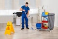 Janitor Mopping Floor In Office Royalty Free Stock Photo