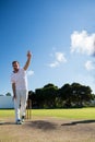 Full length of man bowling while standing on cricket field Royalty Free Stock Photo