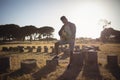 Full length of man playing guitar at forest Royalty Free Stock Photo