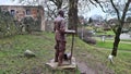 Full-length metal knight near the ruins of an old castle in the Latvian village of Aizpute in January 2023