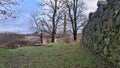 Full-length metal knight near the ruins of an old castle in the Latvian village of Aizpute in January 2023