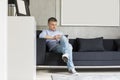 Full-length of Middle-aged man using digital tablet on sofa Royalty Free Stock Photo