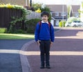 Full length outdoor portrait of preschool kid with backpack waiting for bus, Pupil of primary going to school, Back to school