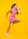 Full length overjoyed teenager kid girl 12 13 14 year jumping old isolated on blue background studio. Funny run and jump