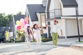 Full length phot of happy family mommy daddy with children walk run jump city celebrate wear party hat harmony childhood